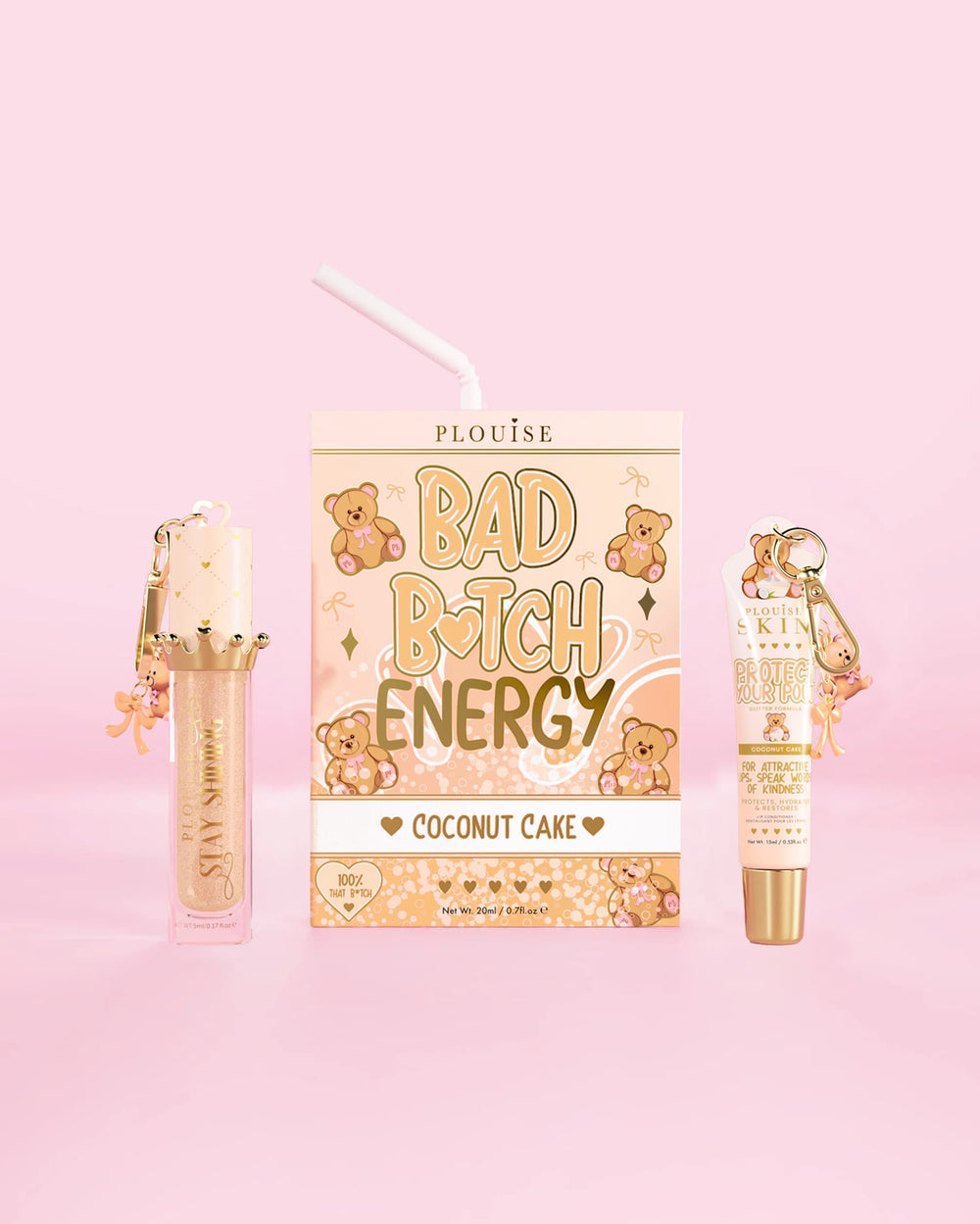 Un dúo de labios P.Louise Teddy Glitter Bad Bitch Energy con aroma a pastel de coco, acondicionador y aceite para labios sobre un fondo rosa.