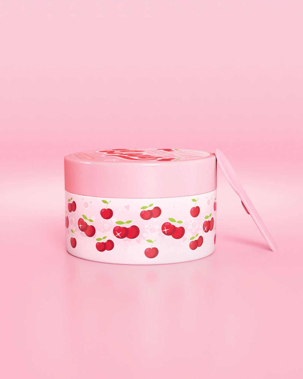 Recipiente rosa com desenho de cereja em um fundo rosa