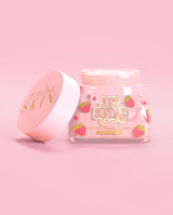Frasco rosa de sorvete de sundae macio P. Louise, hidratante batido com a tampa aberta em um fundo rosa