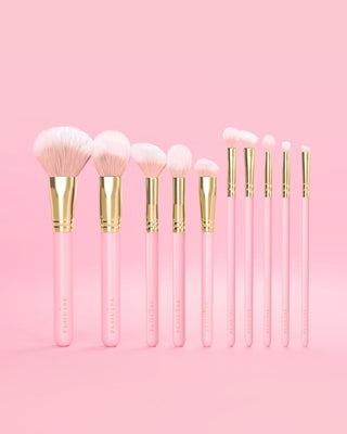 Set of 10 pink P.Louise makeup brushes with pink handles and gold accents on a pink background